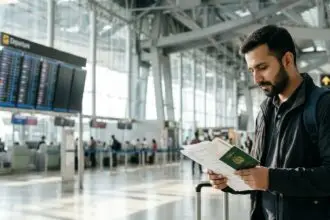 Pakistani traveller preparing passport and travel documents at an international airport before flying abroad